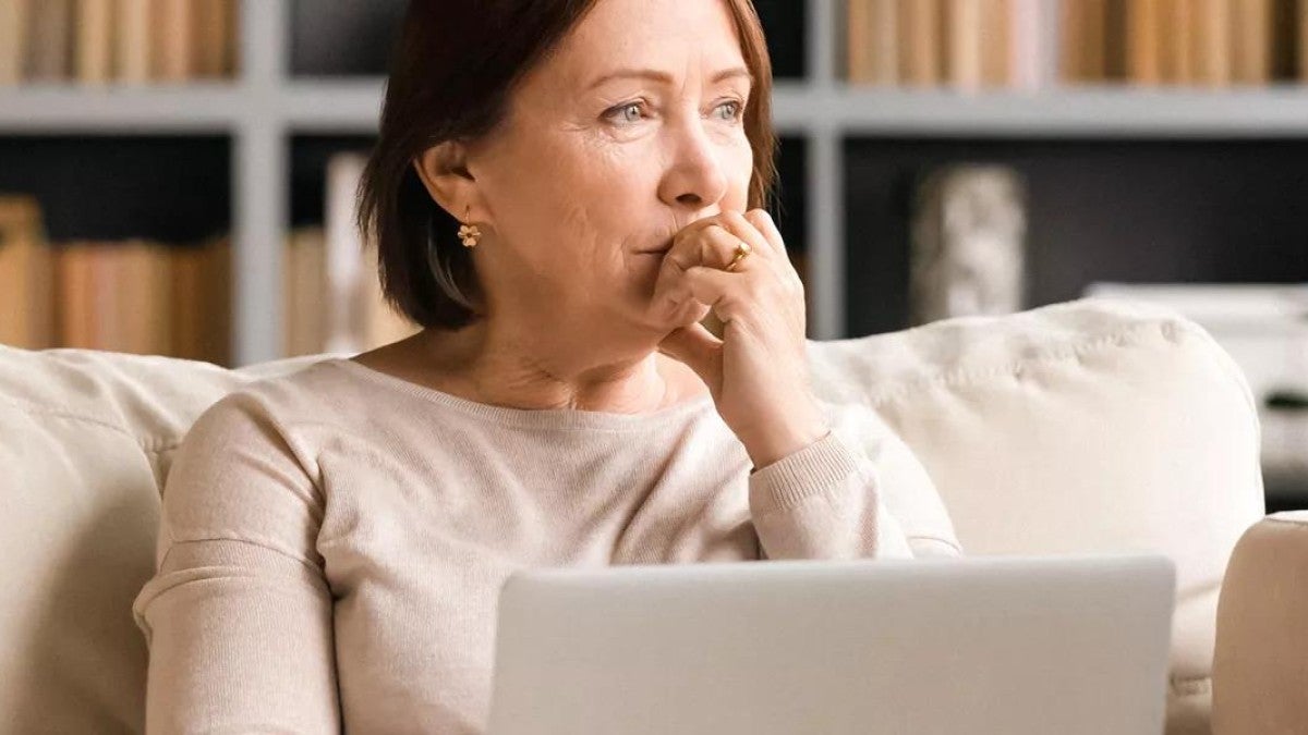 Person sitting on couch pondering their finances