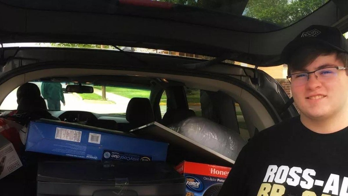 Photo of a boy moving into college.
