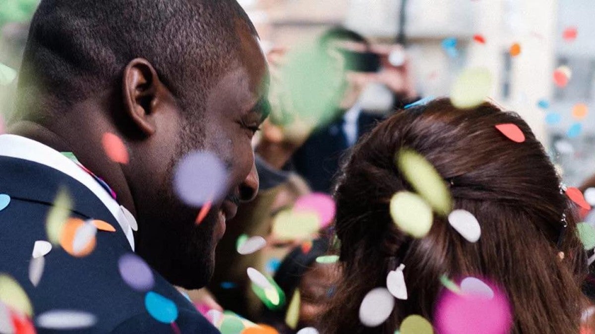 A couple at a new year's party with confetti raining down