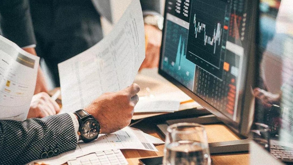 Photo of someone reviewing stock market charts.