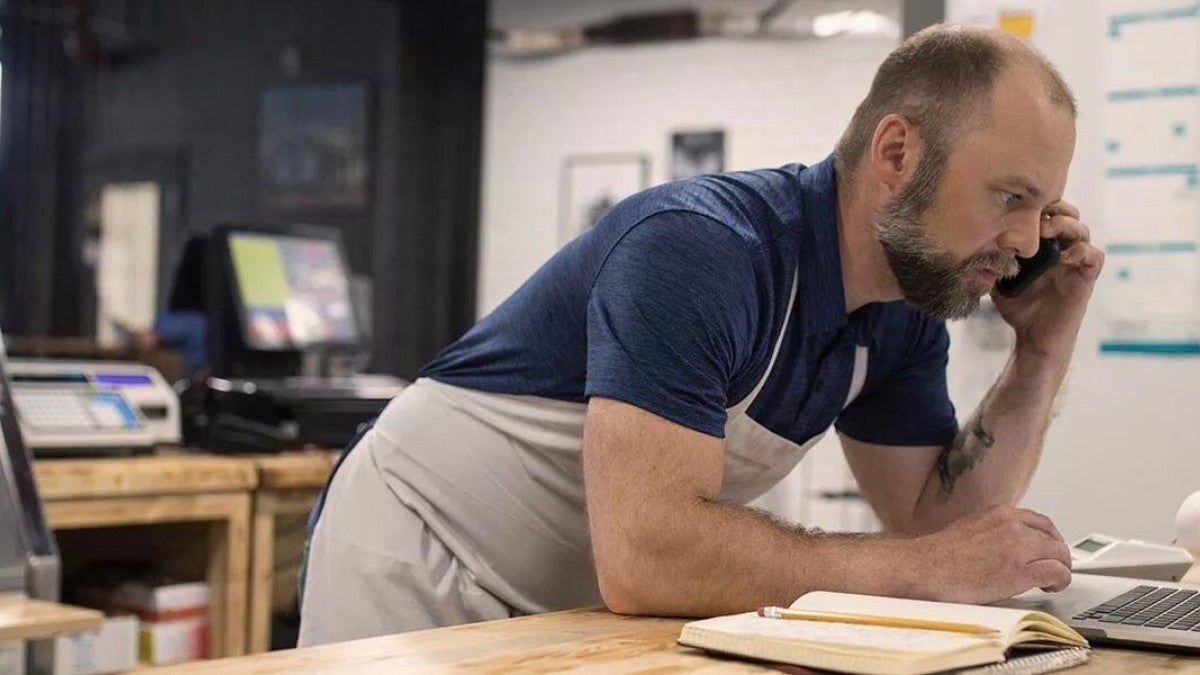 Employee on phone while using computer