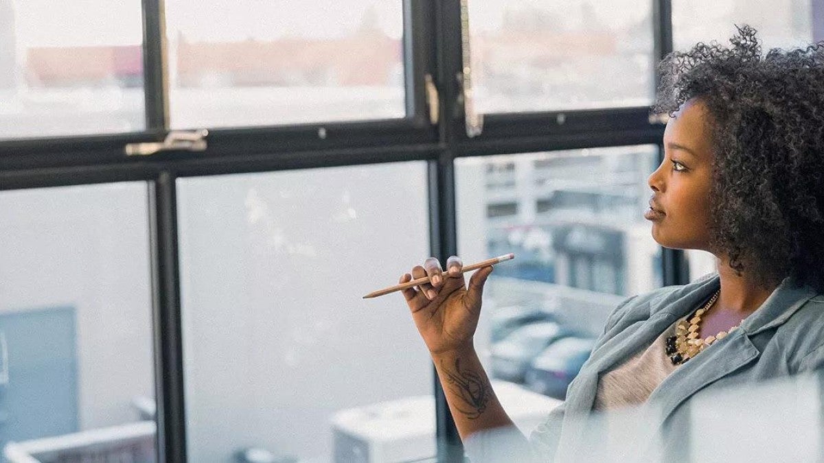 Image of of women sitting in an office, thinking about world events.