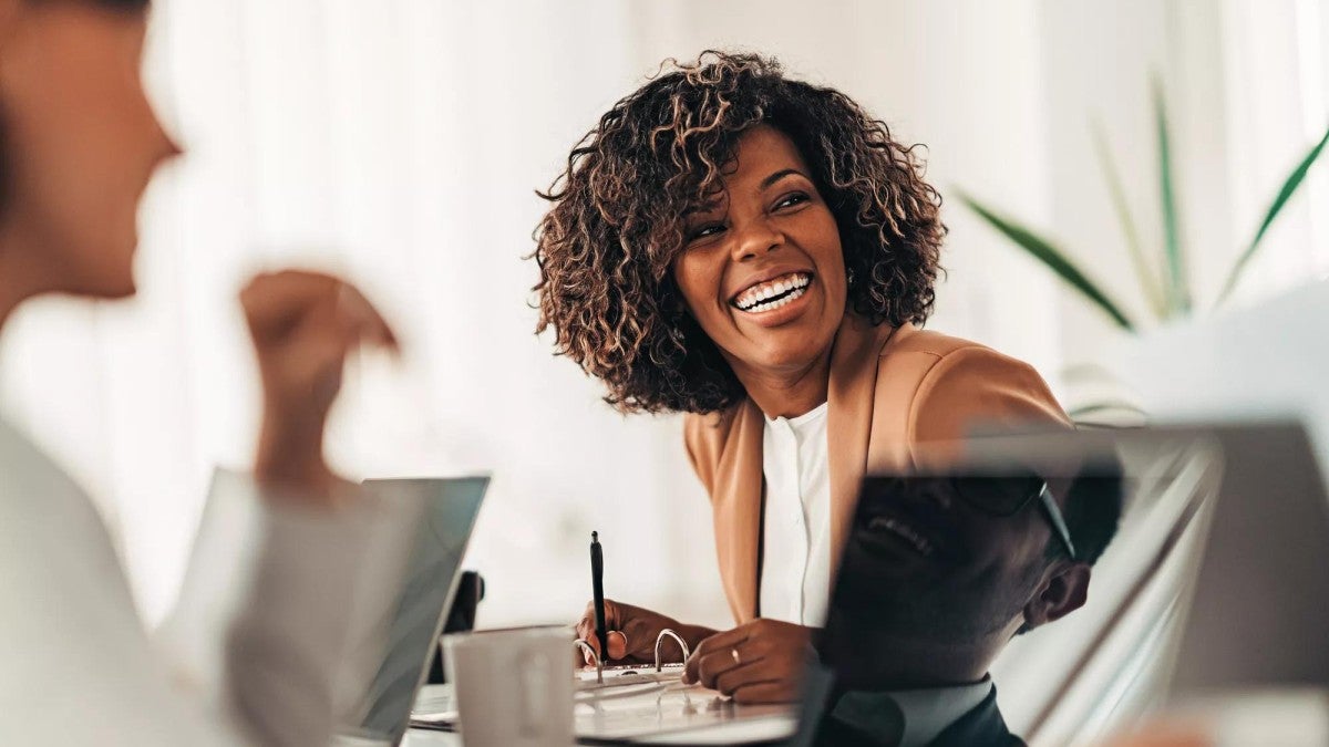 Portrait of cheerful businesswoman smiling at the meeting.
