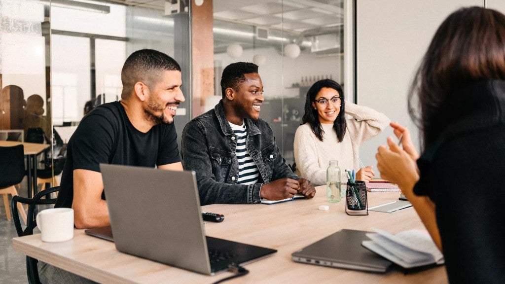 Diverse group of colleagues working around a conference table