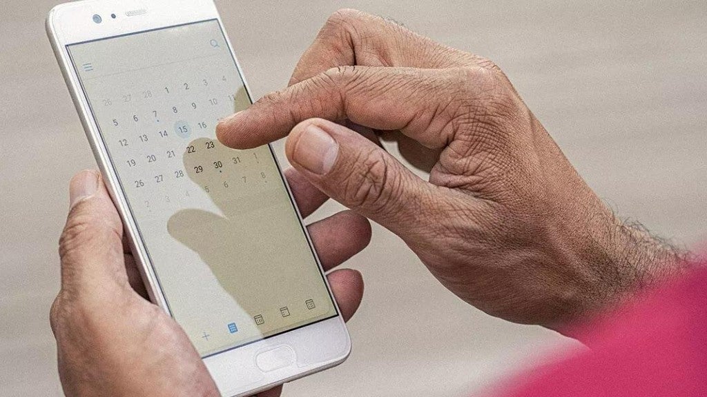 Una persona revisando su calendario en su teléfono