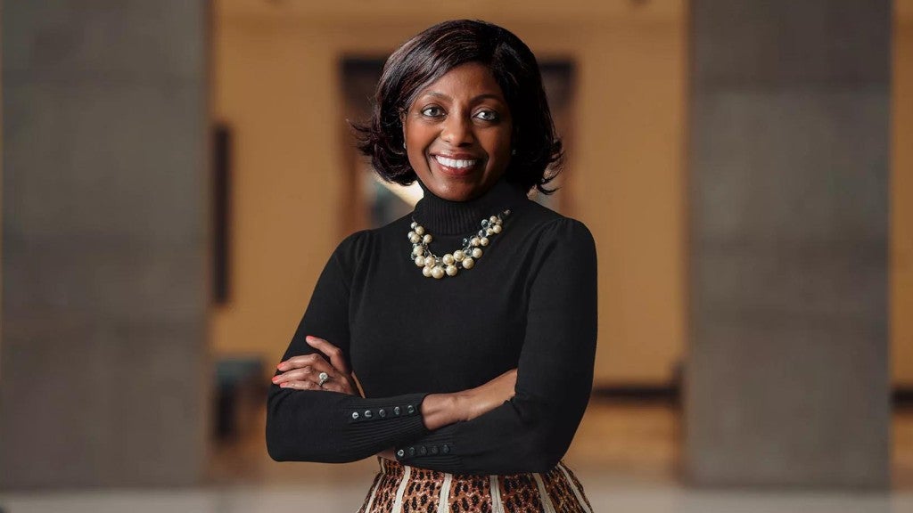 Miriam Lewis standing in Principal headquarters