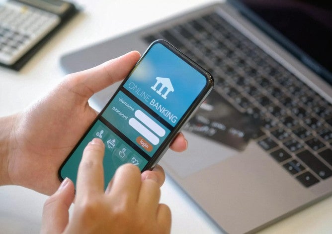 Person logging into an online banking portal on mobile phone