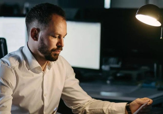 Man looking mildly stressed out at work.