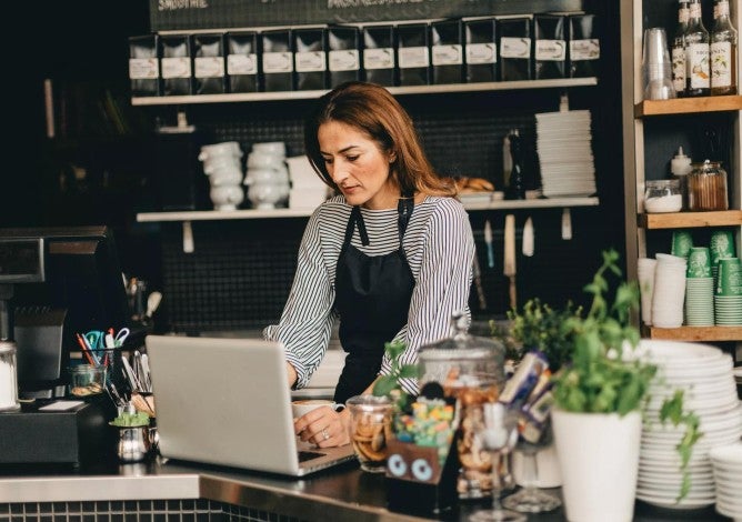 Cafe manager working at computer