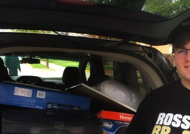 Photo of a boy moving into college.