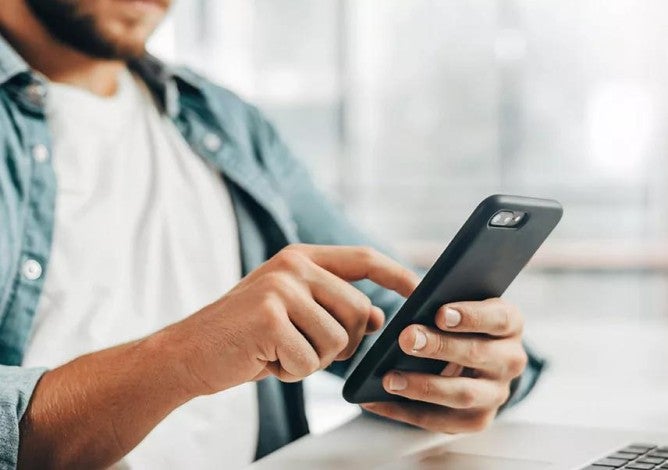 Photo of a man on a cell phone.