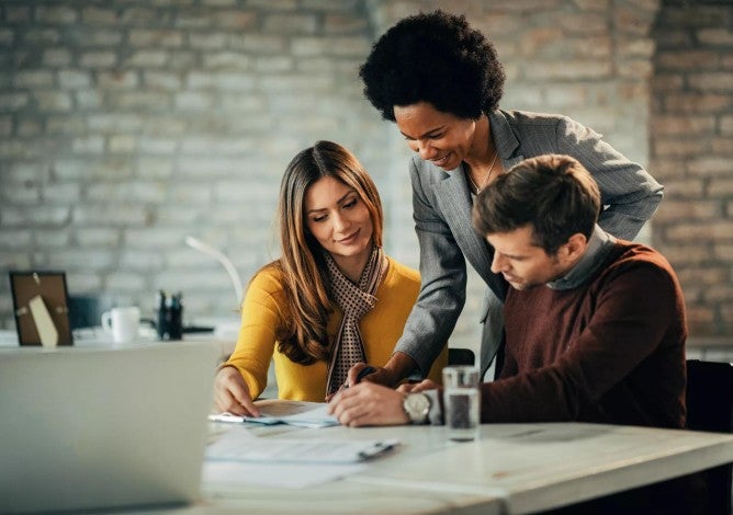 Photo of couple talking with a financial advisor.