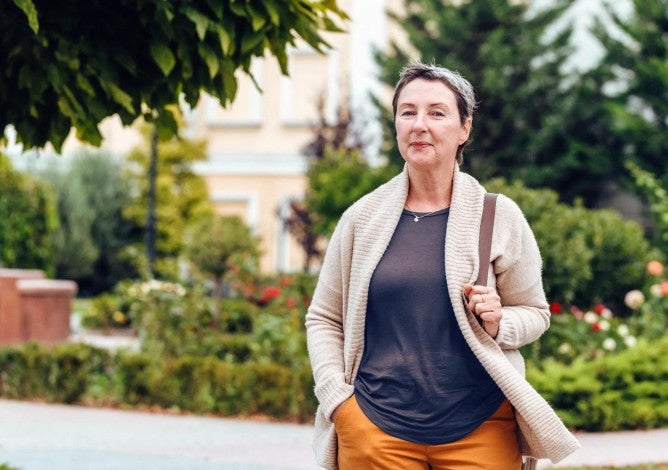 Confident senior woman in park setting.