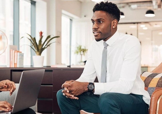 Photo of two people talking in an office.