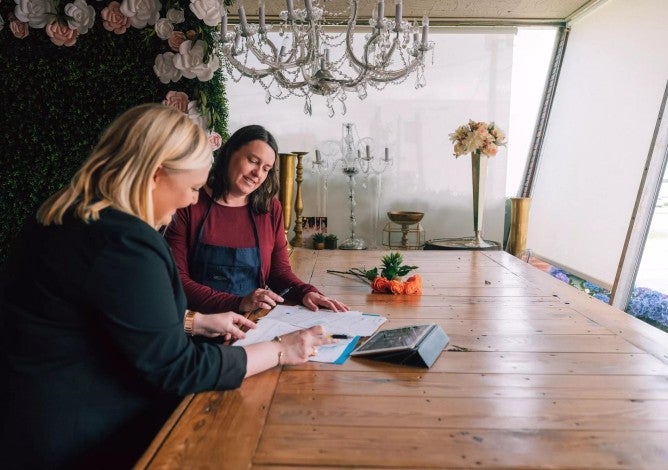 Photo of a woman talking with a financial professional.