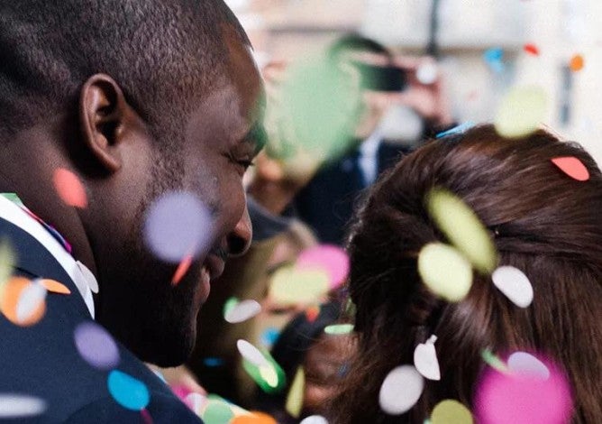 A couple at a new year's party with confetti raining down