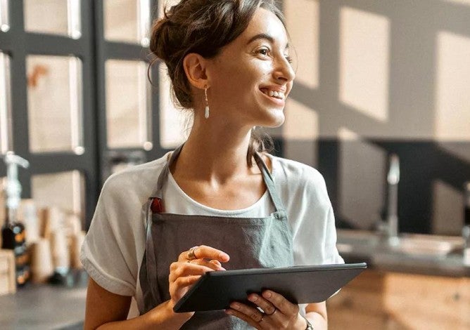 Photo of a businesswoman holding a tablet.