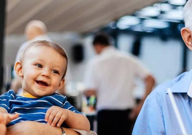 Grandparents With Their Grandson At Cafe