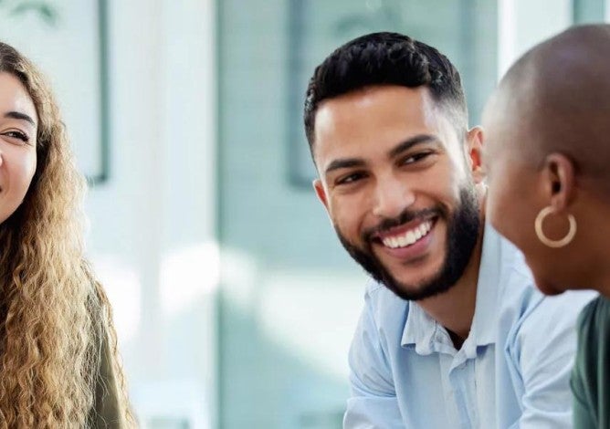 Business people smile during a planning meeting.