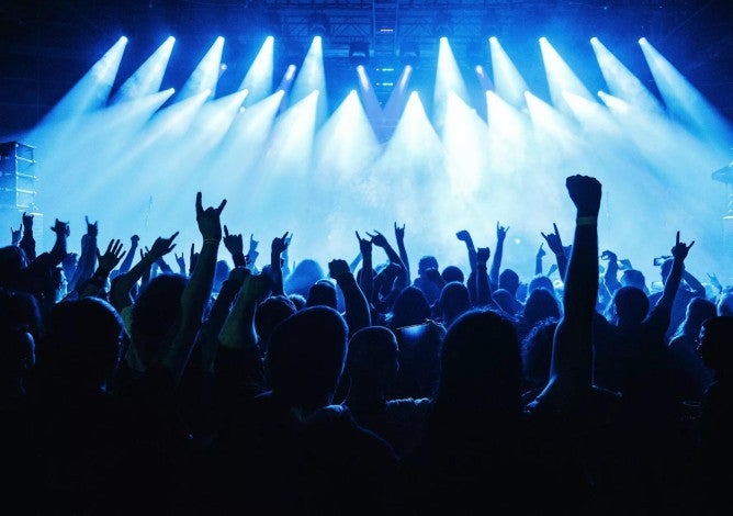 Crowd raising hand in the air and enjoying concert on a festival.