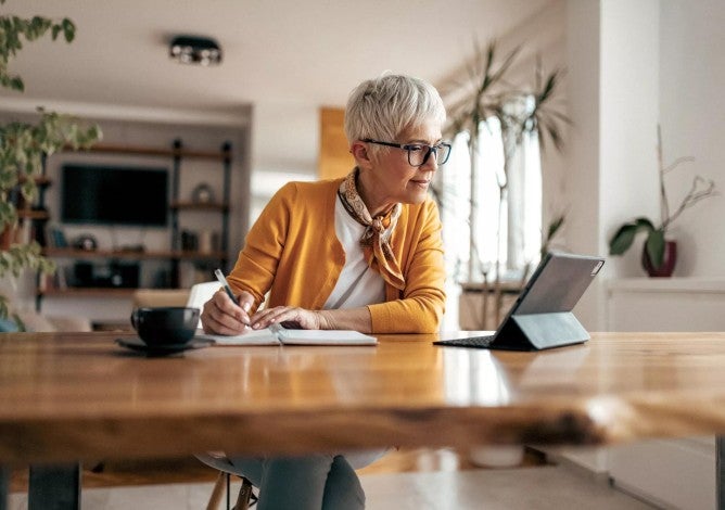 Senior businesswoman, working hard, from home office.