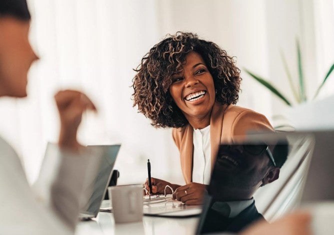 Portrait of cheerful businesswoman smiling at the meeting.