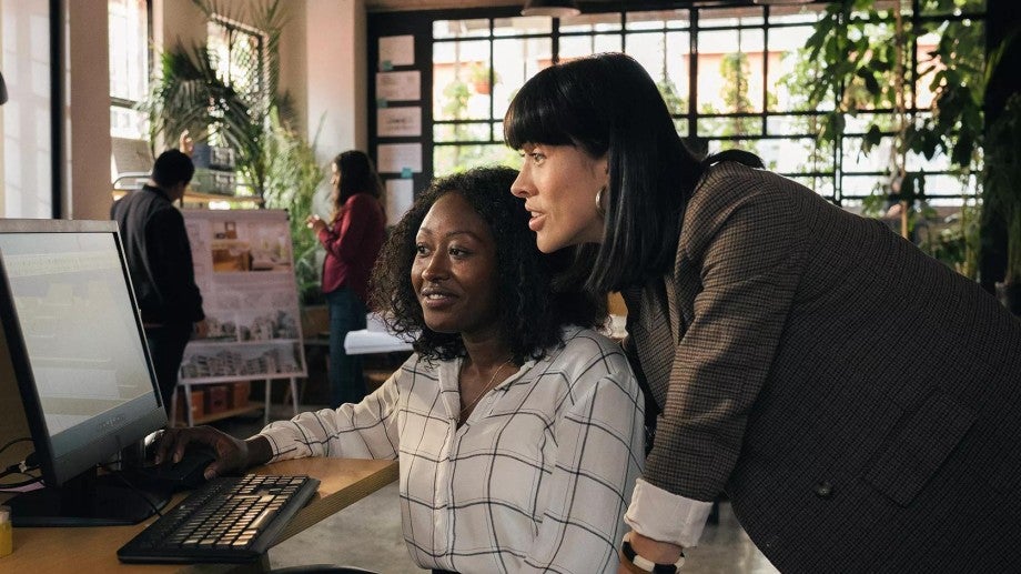 Two women looking at computer.