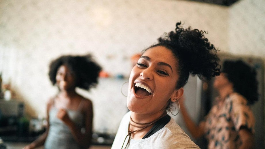 Photo of friends smiling and dancing