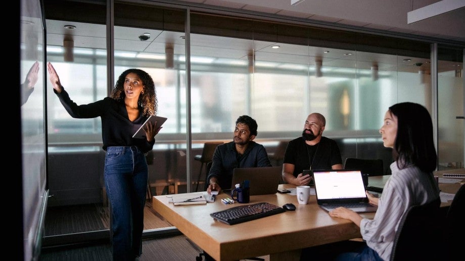 Employee giving a presentation in front of colleagues