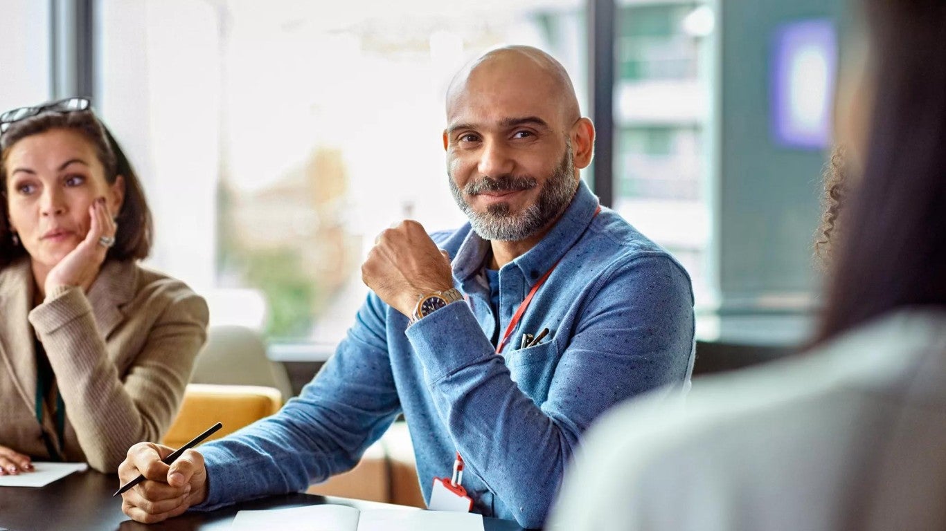 Employee at a large business in a meeting. Employee at a large business in a meeting.