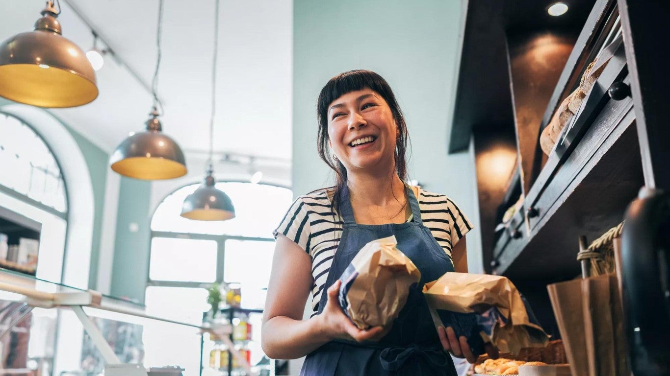 Small business owner at a grocery store counter. Small business owner at a grocery store counter.