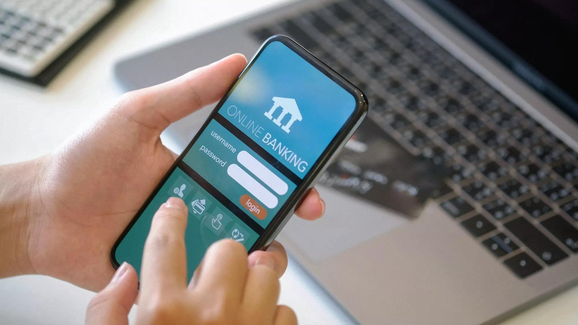 Person logging into an online banking portal on mobile phone