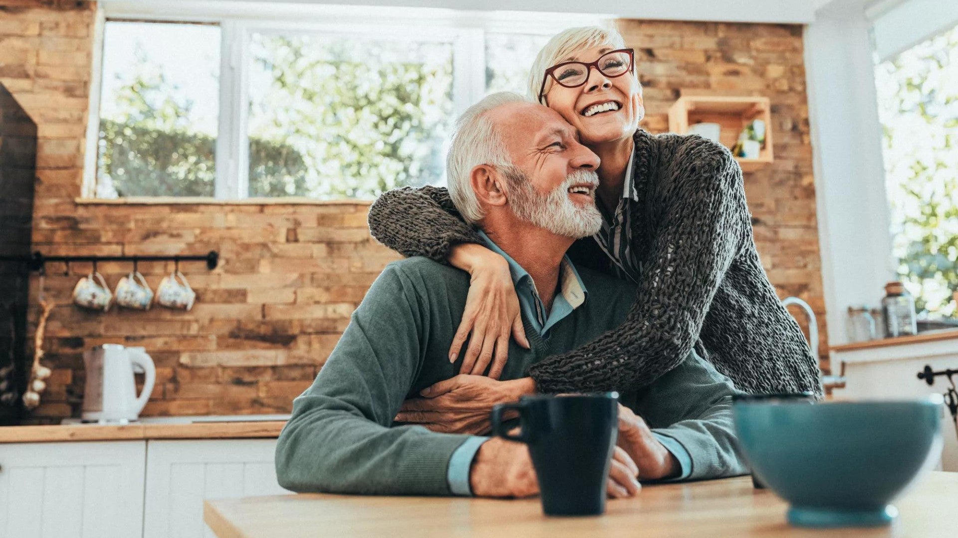 Smiling older man and woman in their home.