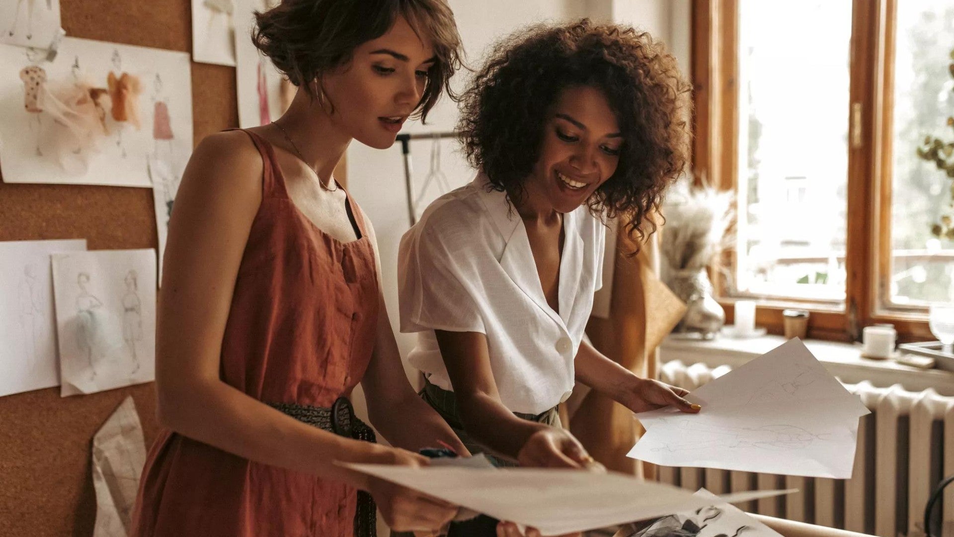 Two women thoughtfully looking over papers