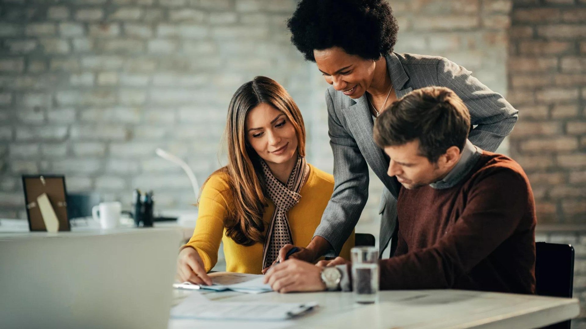 Photo of couple talking with a financial advisor.