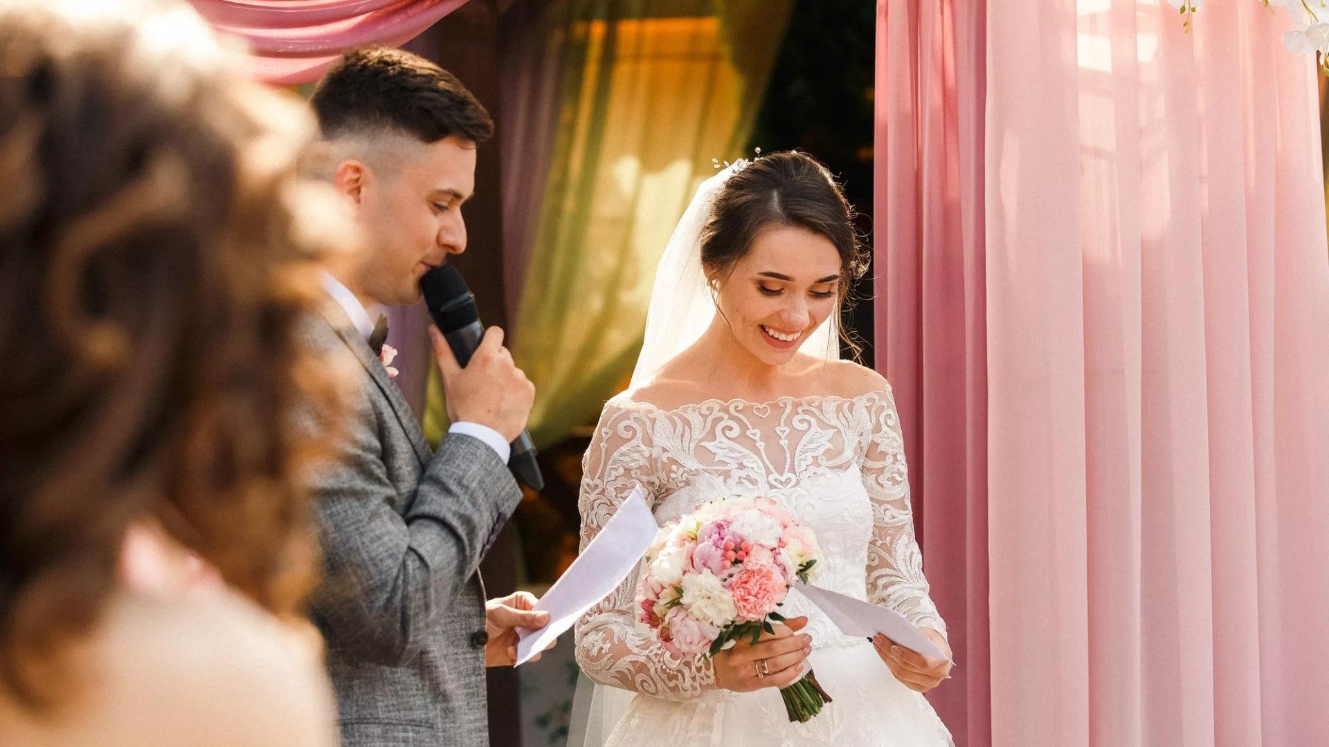 Man and woman reading their wedding vows.