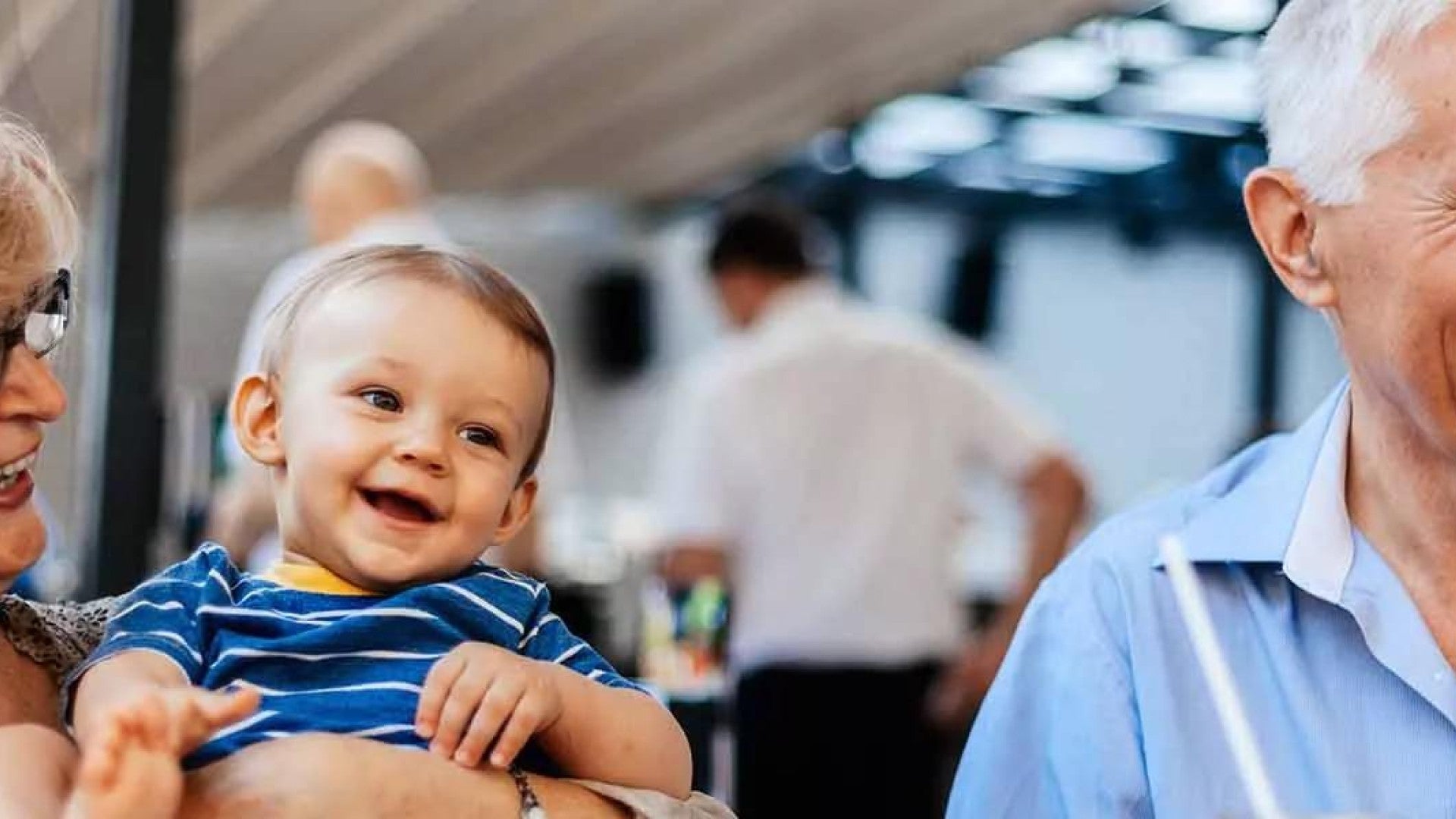 Grandparents With Their Grandson At Cafe