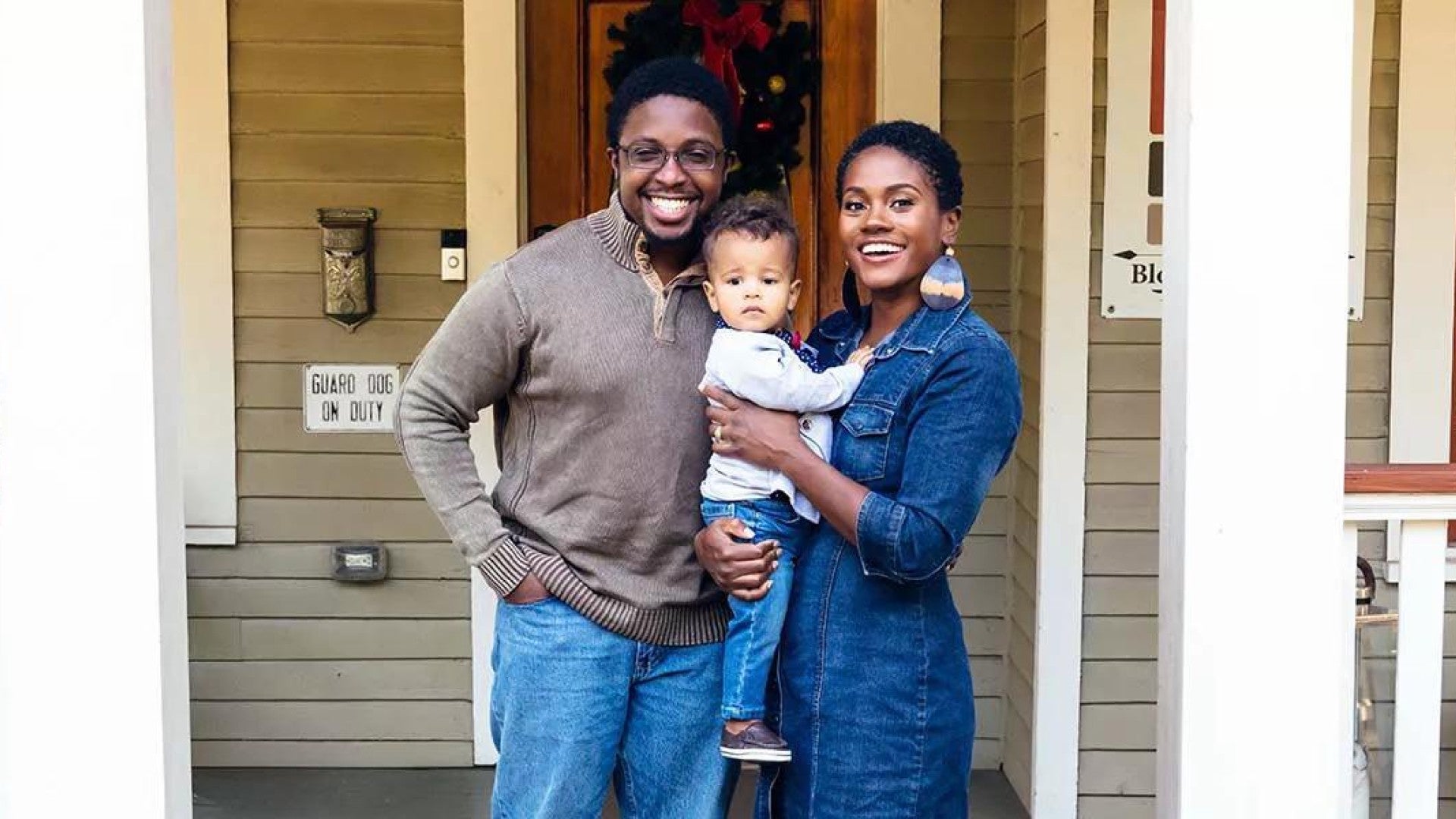 Portrait of black family and child in front of home for the holidays