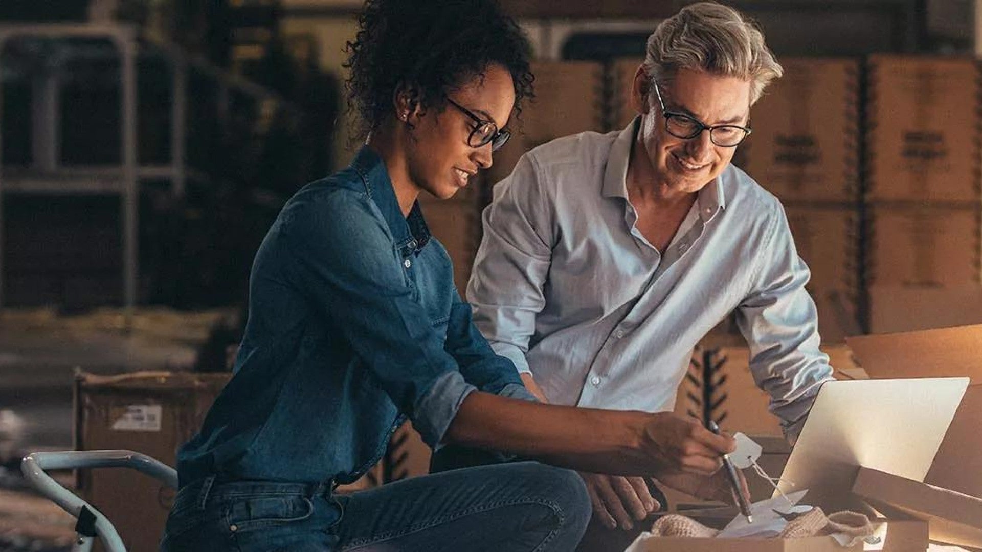 Photo of two people looking at a computer.