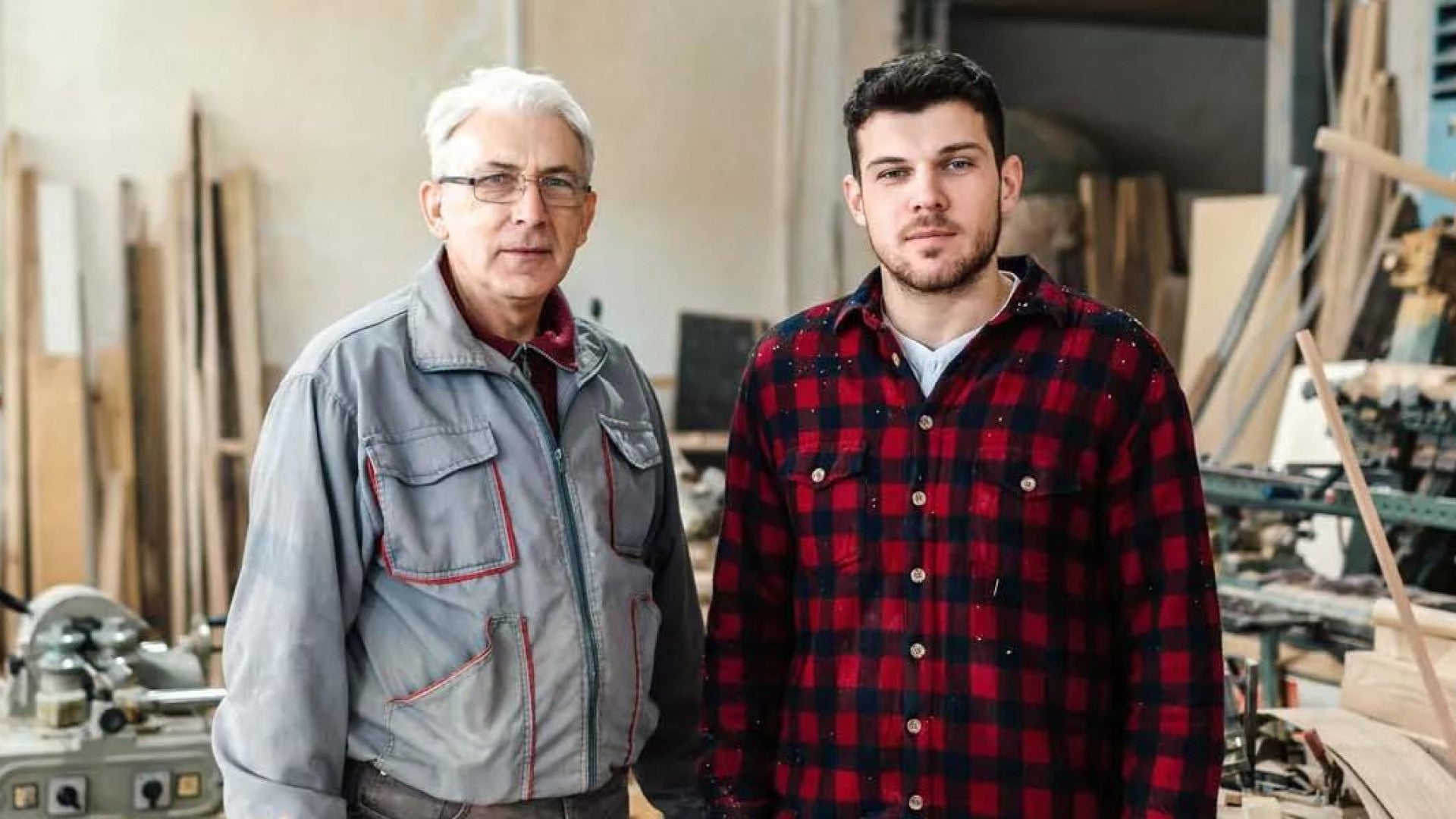 A business owner and his son standing in their production facility.