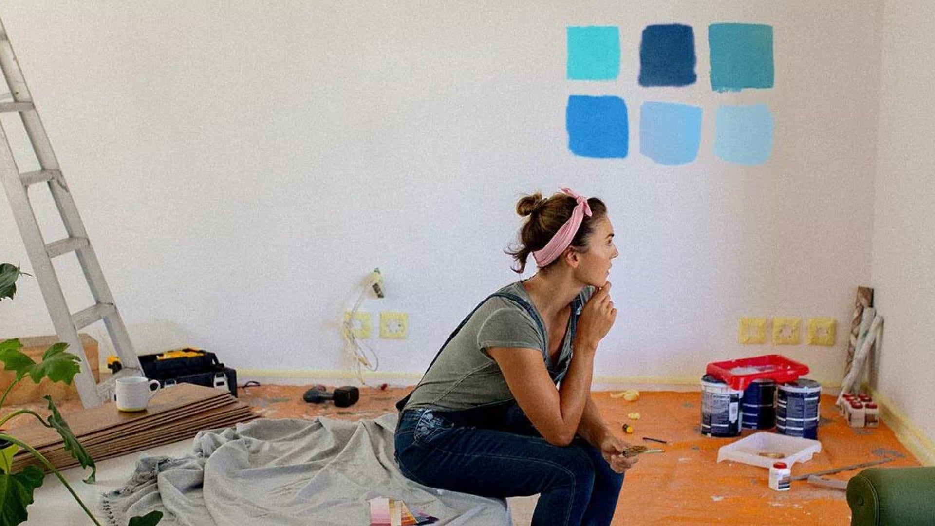 Image of a woman considering paint colors in her home.