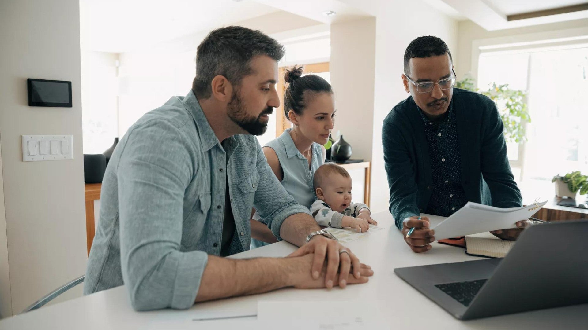 3 coworkers work around a laptop