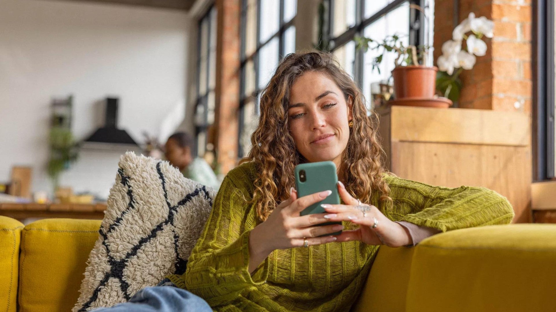 Female student using her smartphone to check her personal finances.