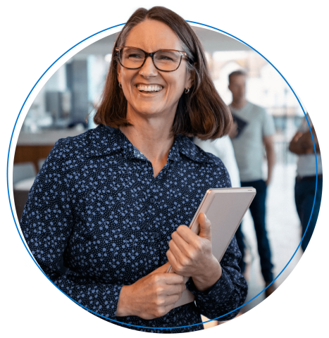 Three coworkers engage in a conversation outside a meeting area.